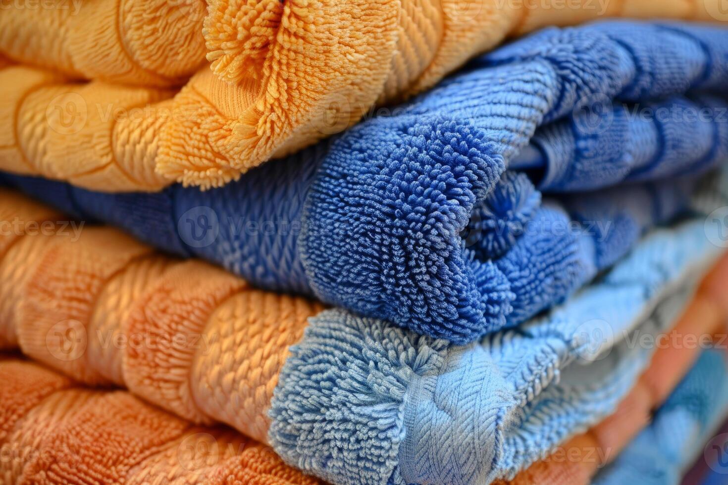 Stack of soft blue and orange towels folded on top of each other photo