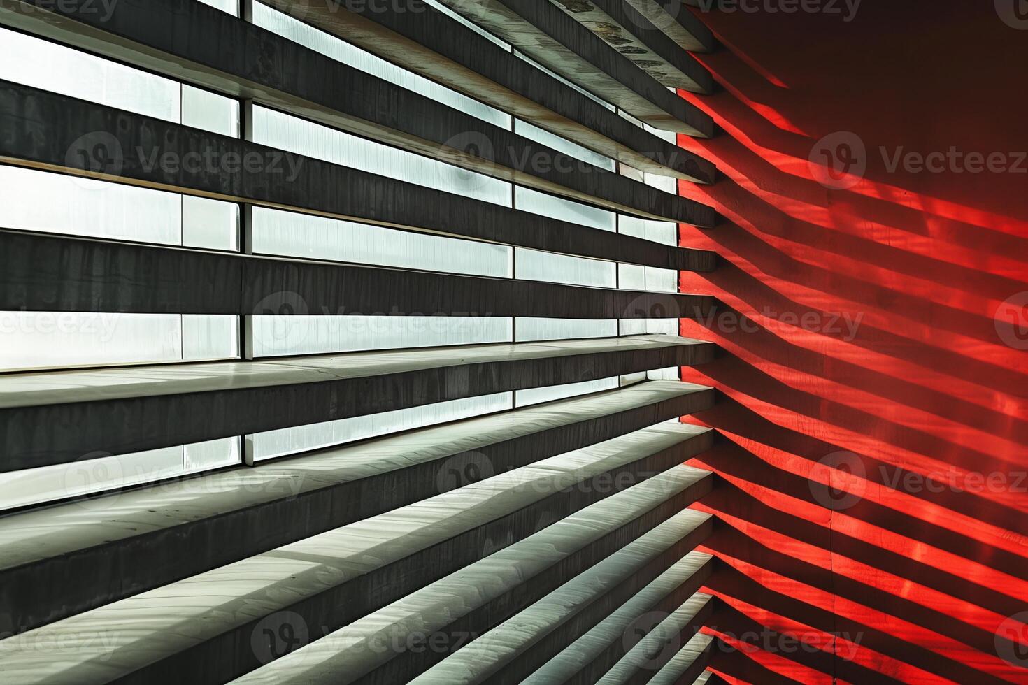 Modern architecture featuring red wall and sunlight shining through window photo