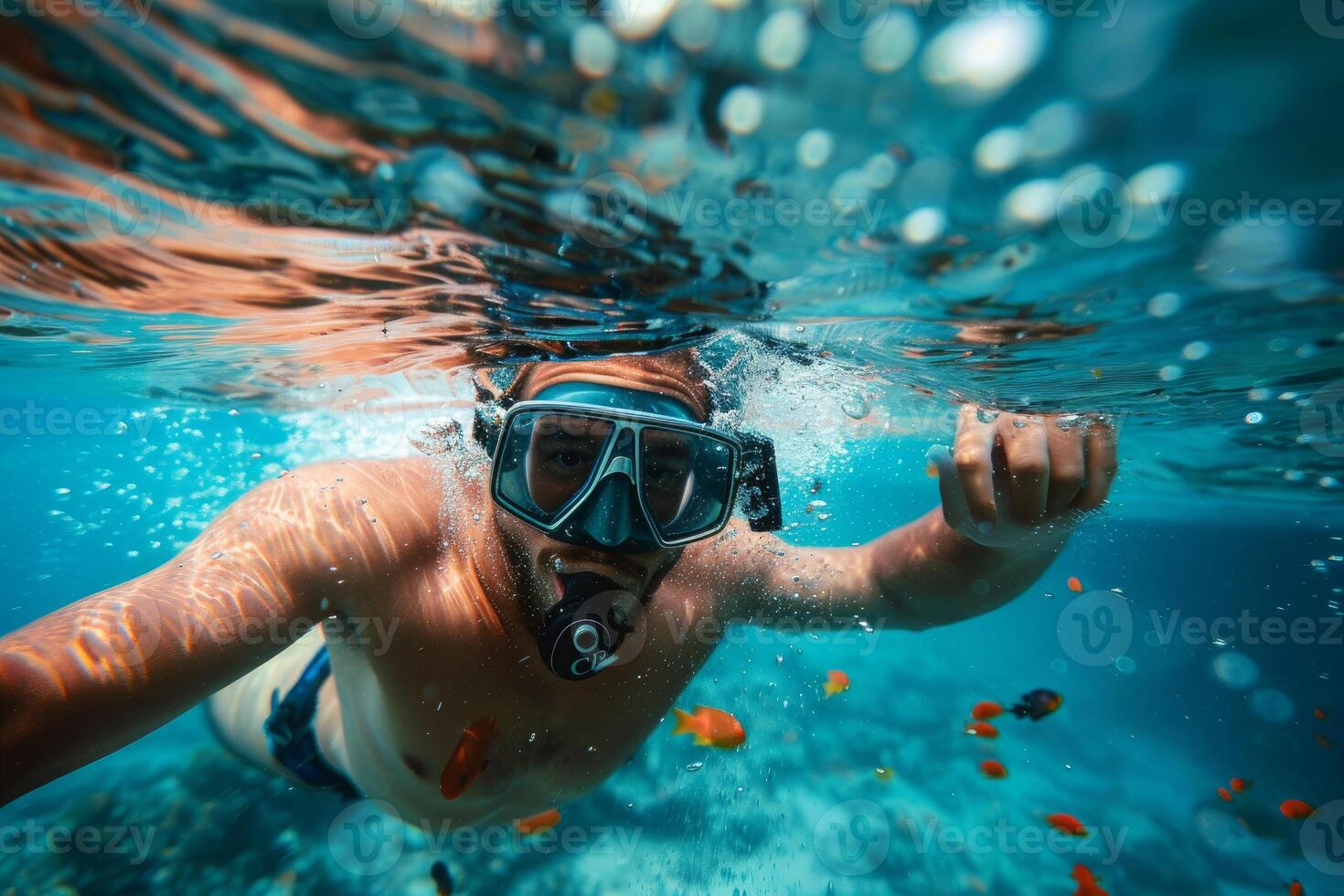 Tourist wearing snorkel mask swimming underwater exploring tropical reef photo