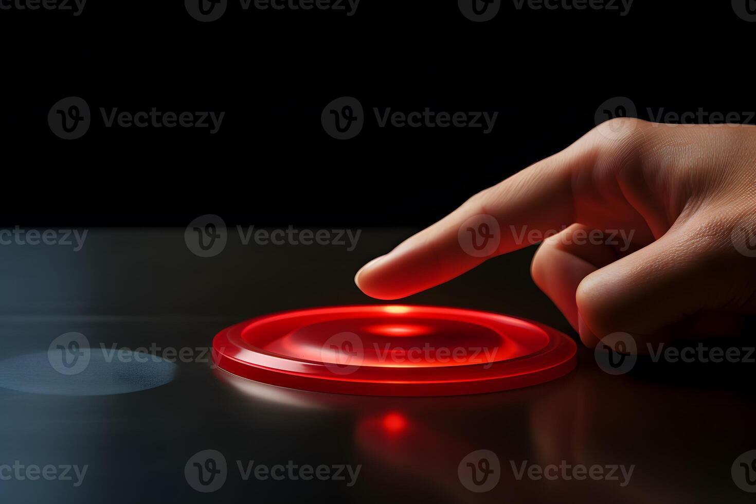 A hand presses a red button on a dark background. Nuclear strike concept photo