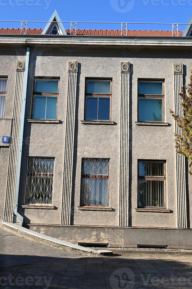 a building with many windows and a red roof photo