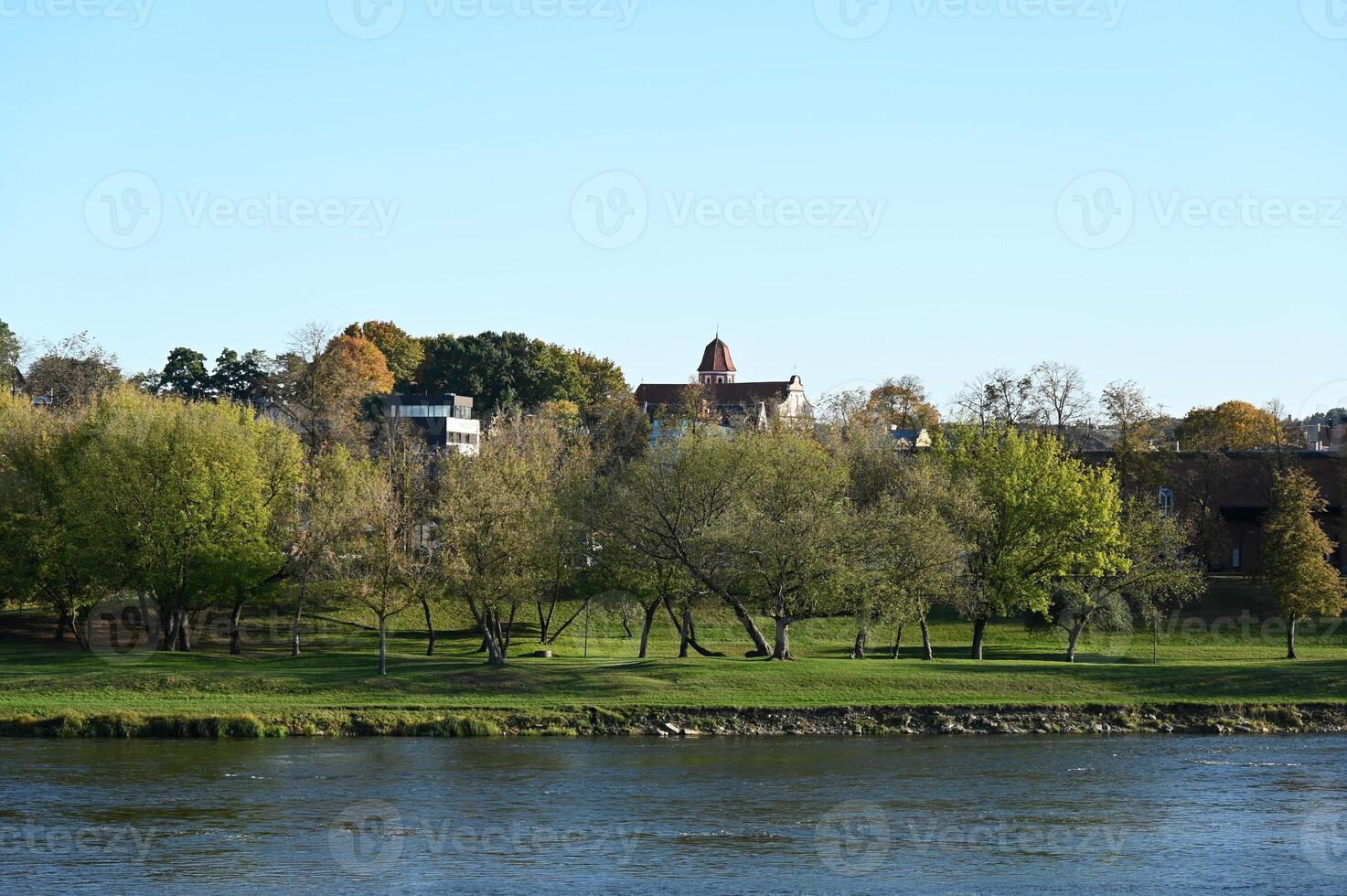 a river with a bridge and trees in the background photo