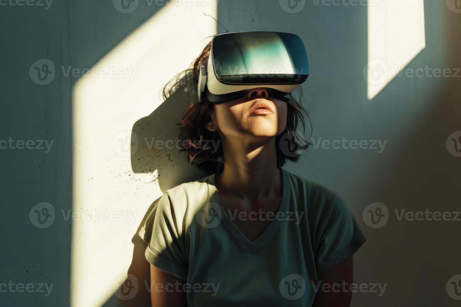 Woman leaning against a wall, wearing a virtual reality headset, experiencing vertigo and side effects of VR experience photo
