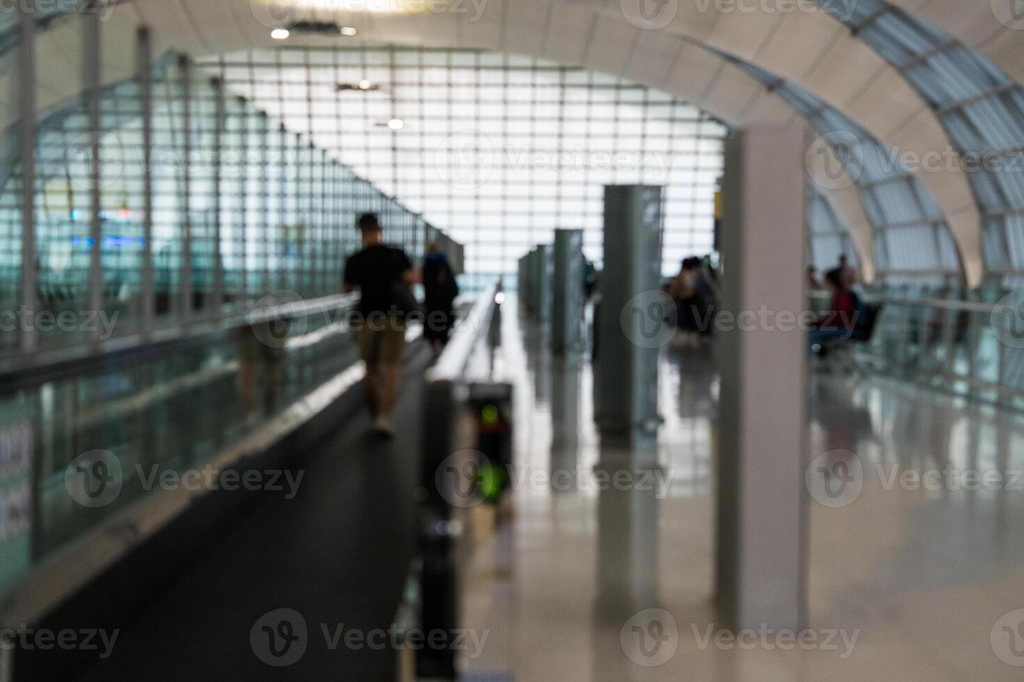 Blurred people walking on the walkway airport at airport. photo