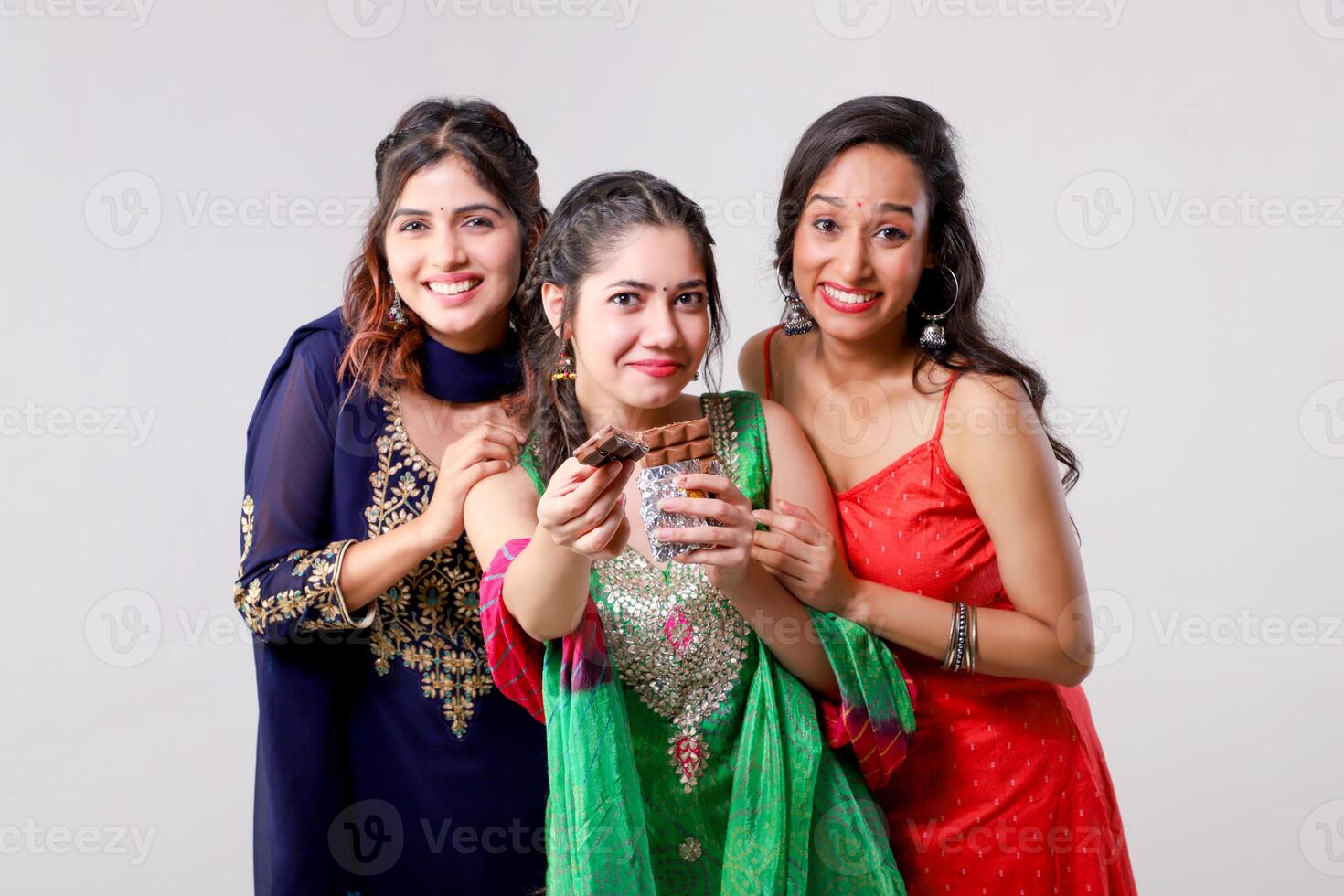 Attractive Female Models Showing Chocolate Bar in Front of Camera photo