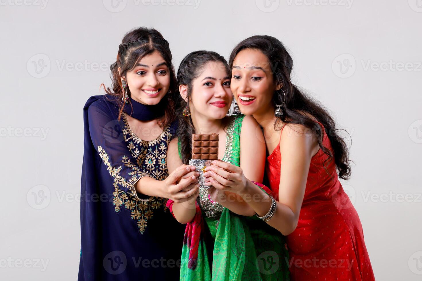Asian Female Models With Temptation Expression Looking Towards the Chocolate Bar photo