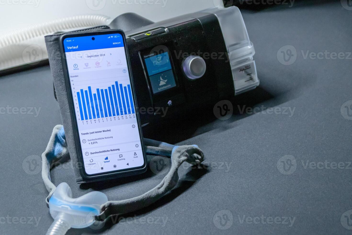 CPAP machine with nose CPAP mask and smartphone with digital app for treatment stats and medical reports or health reports and digital assistant for therapy analysis and therapy reports patient files photo
