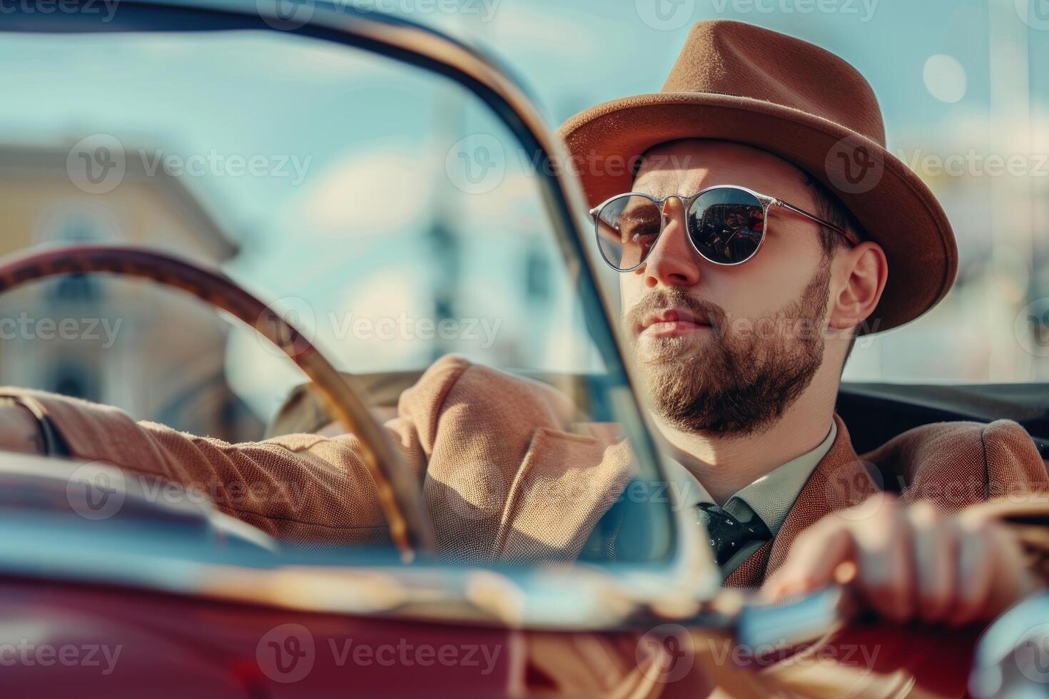 Stylish man wearing hat and sunglasses driving vintage convertible car photo