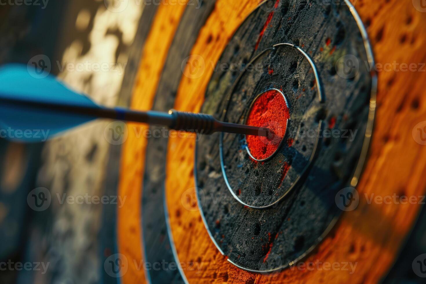 Blue arrow hitting the center of an archery target photo