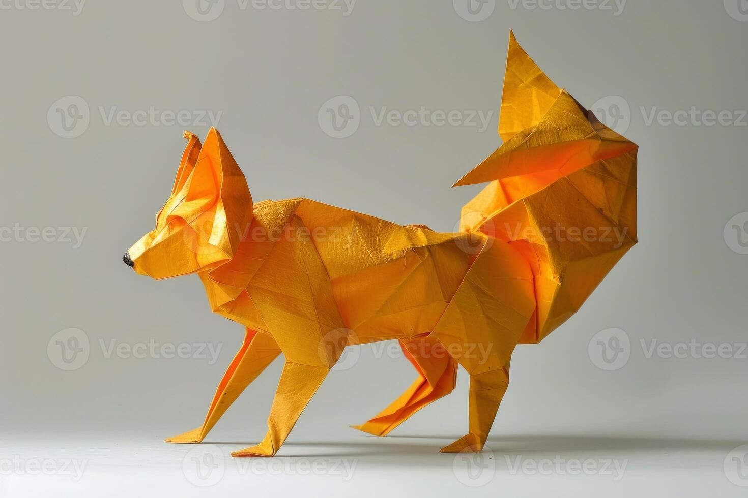 Yellow origami fox standing on white background photo