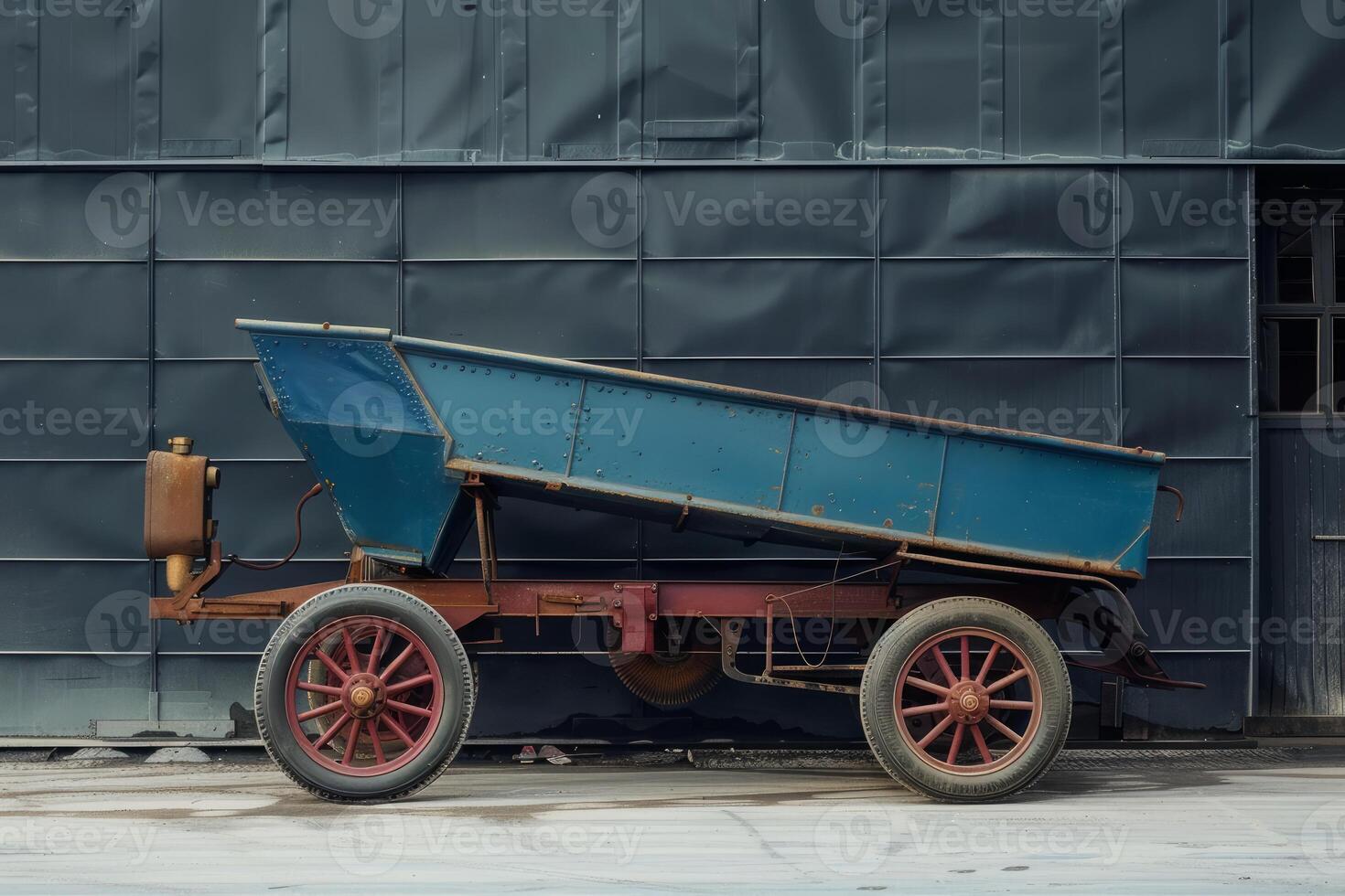 Old rusty blue mining cart standing outside a factory photo