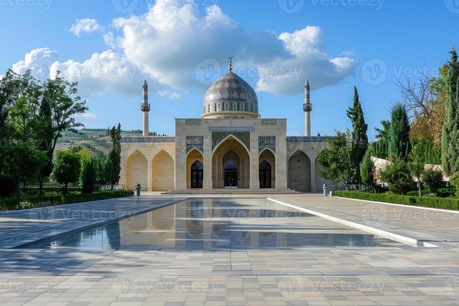 Impressive modern mosque building reflecting on water surface on sunny day photo