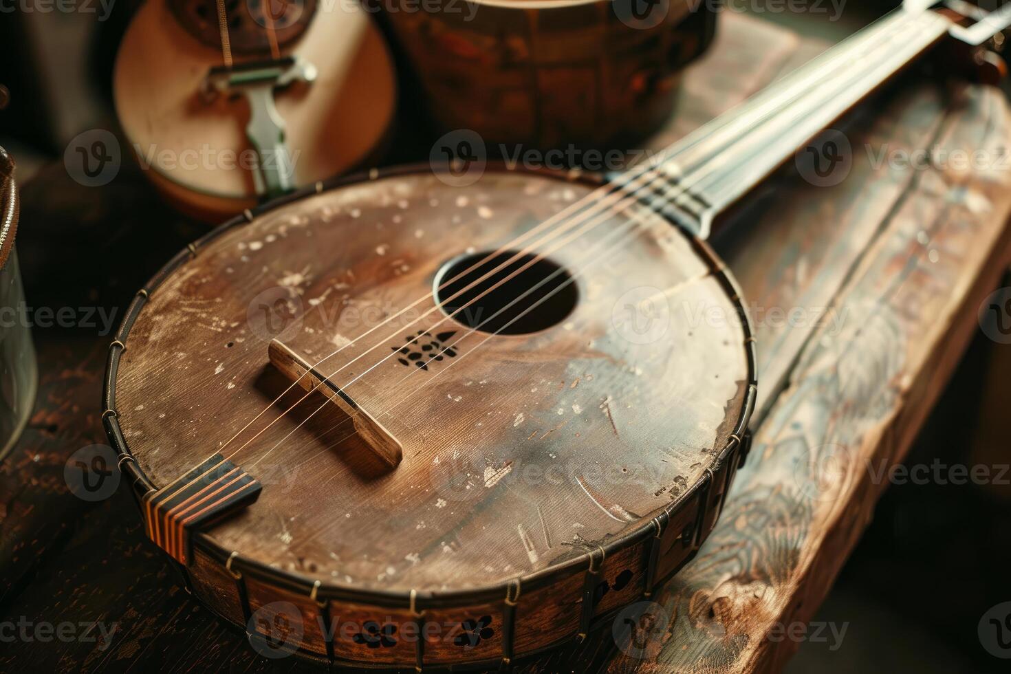 Old banjo resting on rustic wooden surface in workshop photo