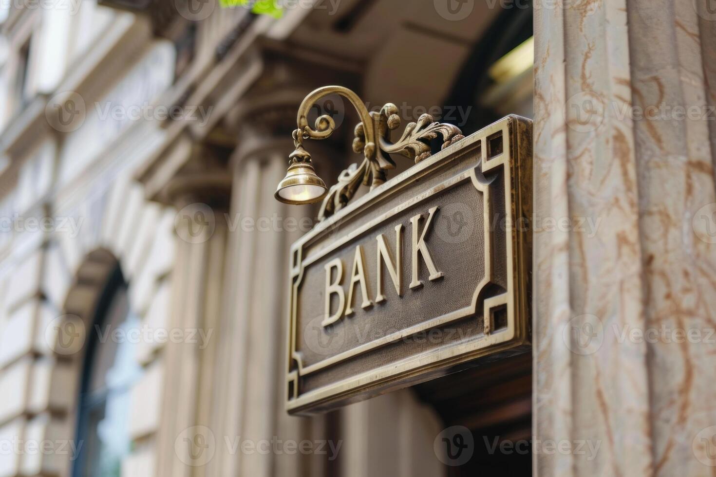 Ornate golden bank sign hanging on building facade photo