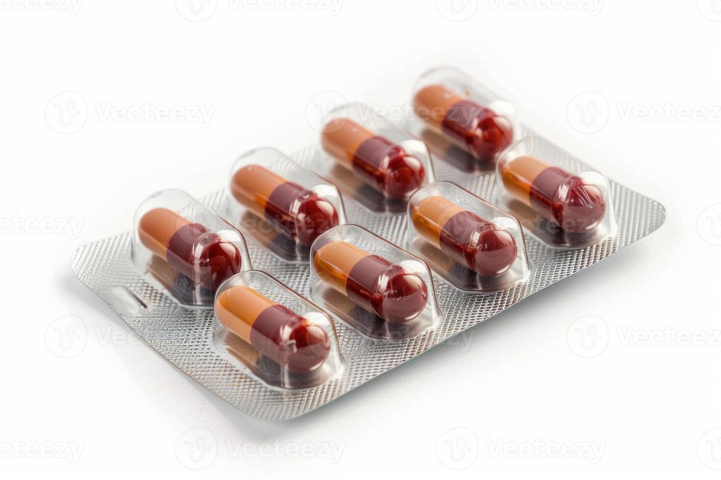 Blister pack containing red and brown pills lying on white background photo