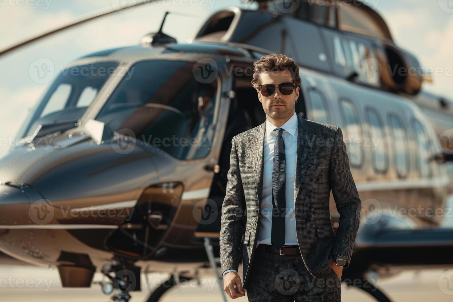 Businessman waiting near private helicopter on helipad photo
