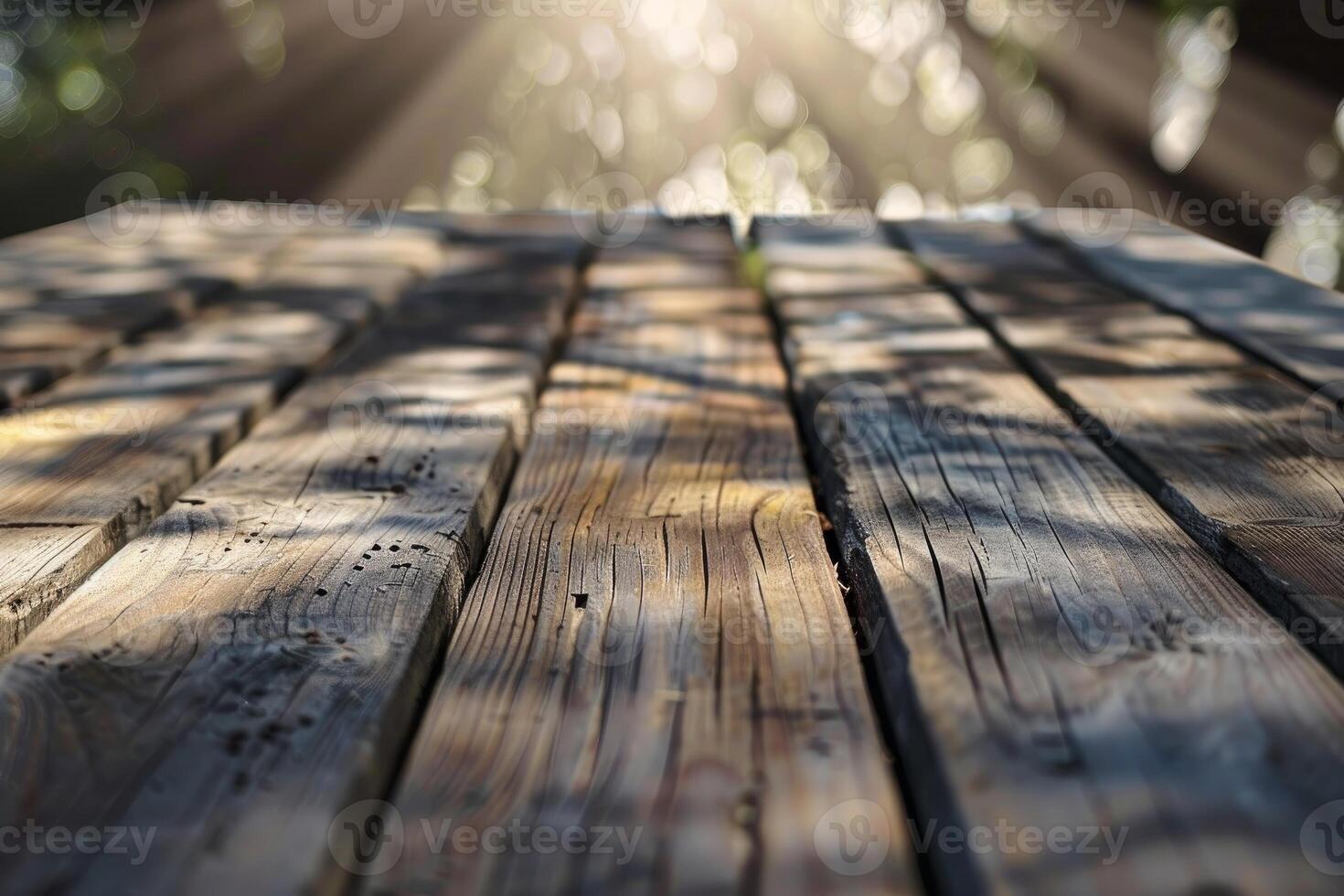 Warm sunlight filters through leaves, casting a soft glow on a rustic wooden table photo