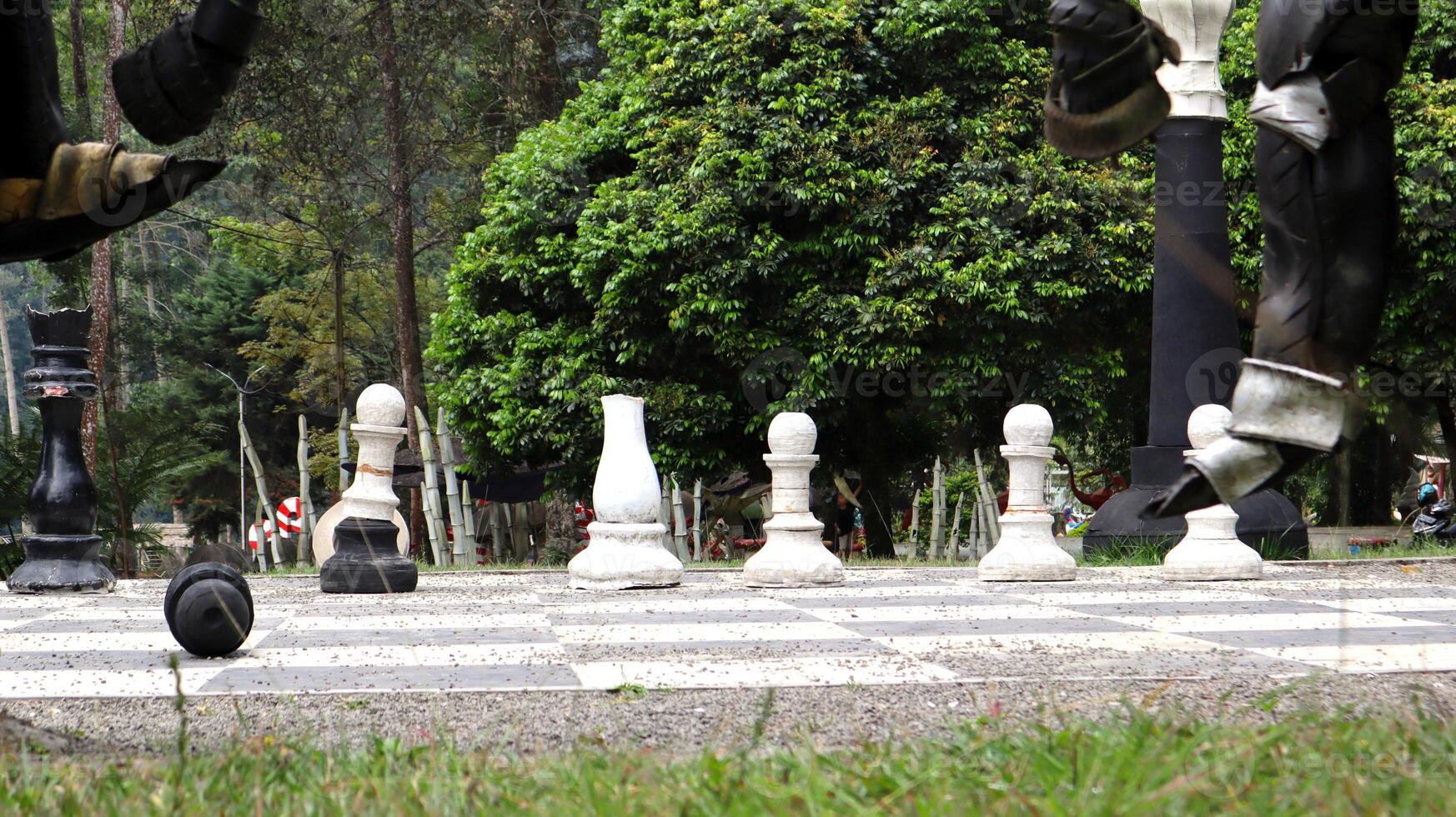 Giant chess on the board located on the ground photo