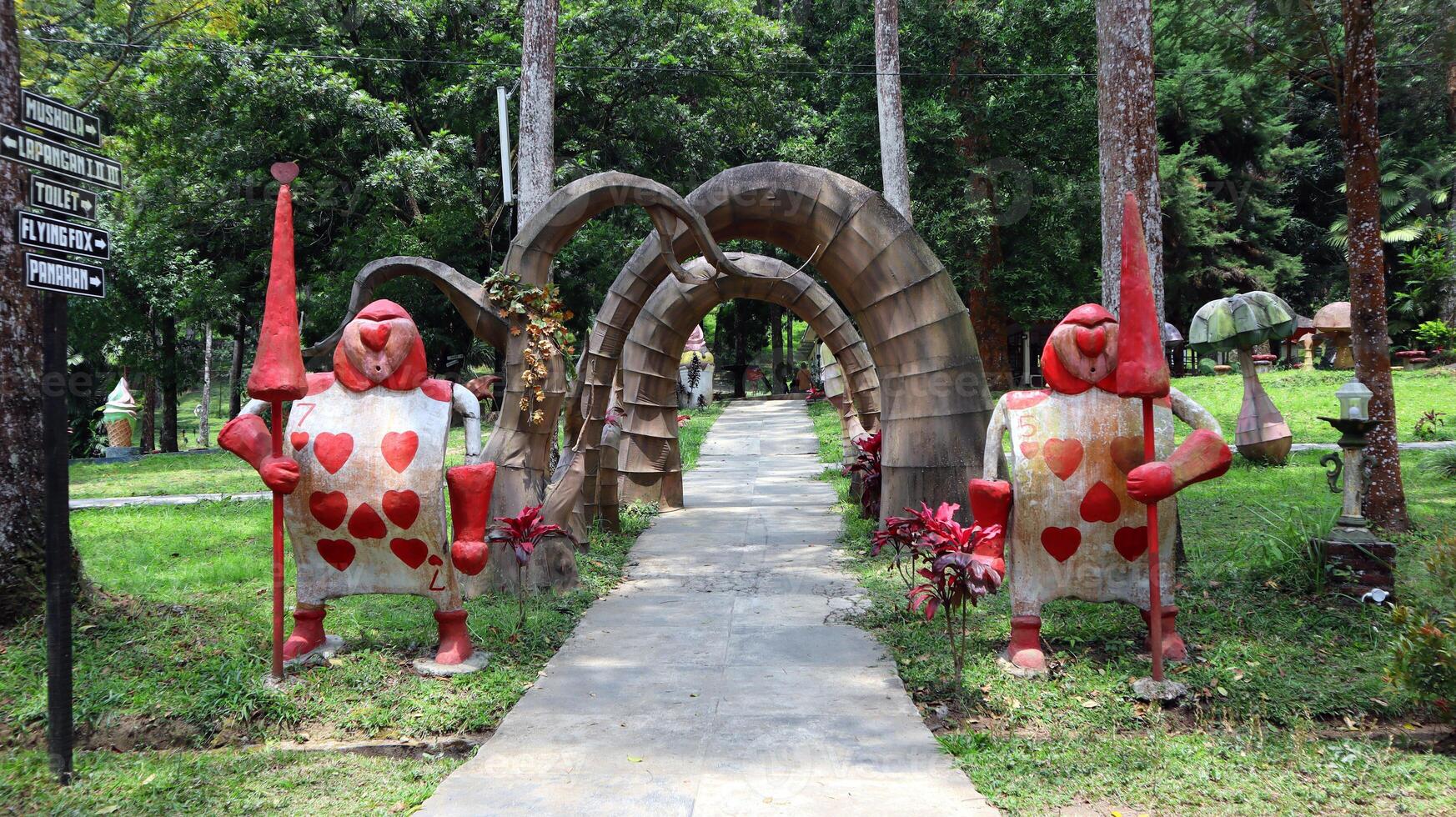 Two cute guard statues at the entrance gate with a heart card at the Wonder Park Tawangmangu Indonesia photo