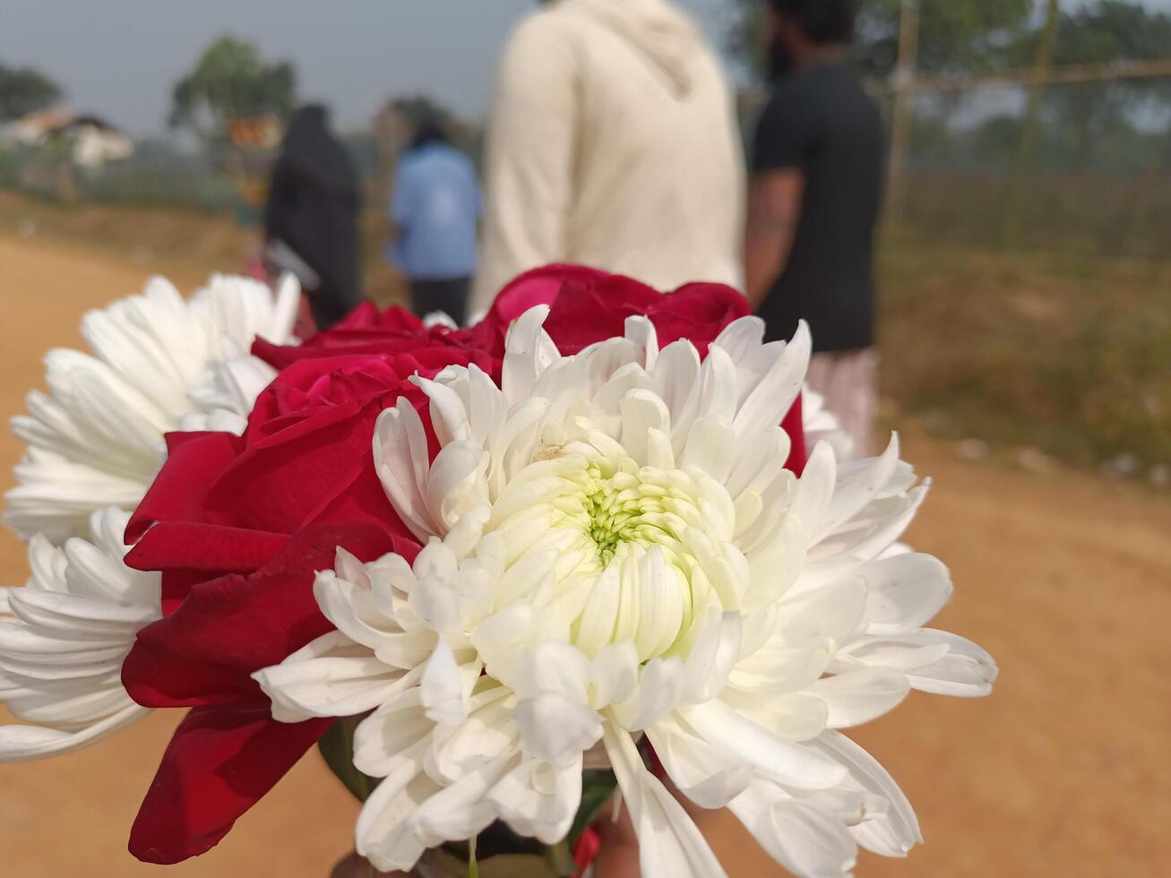 A person holding a bouquet of flowers photo