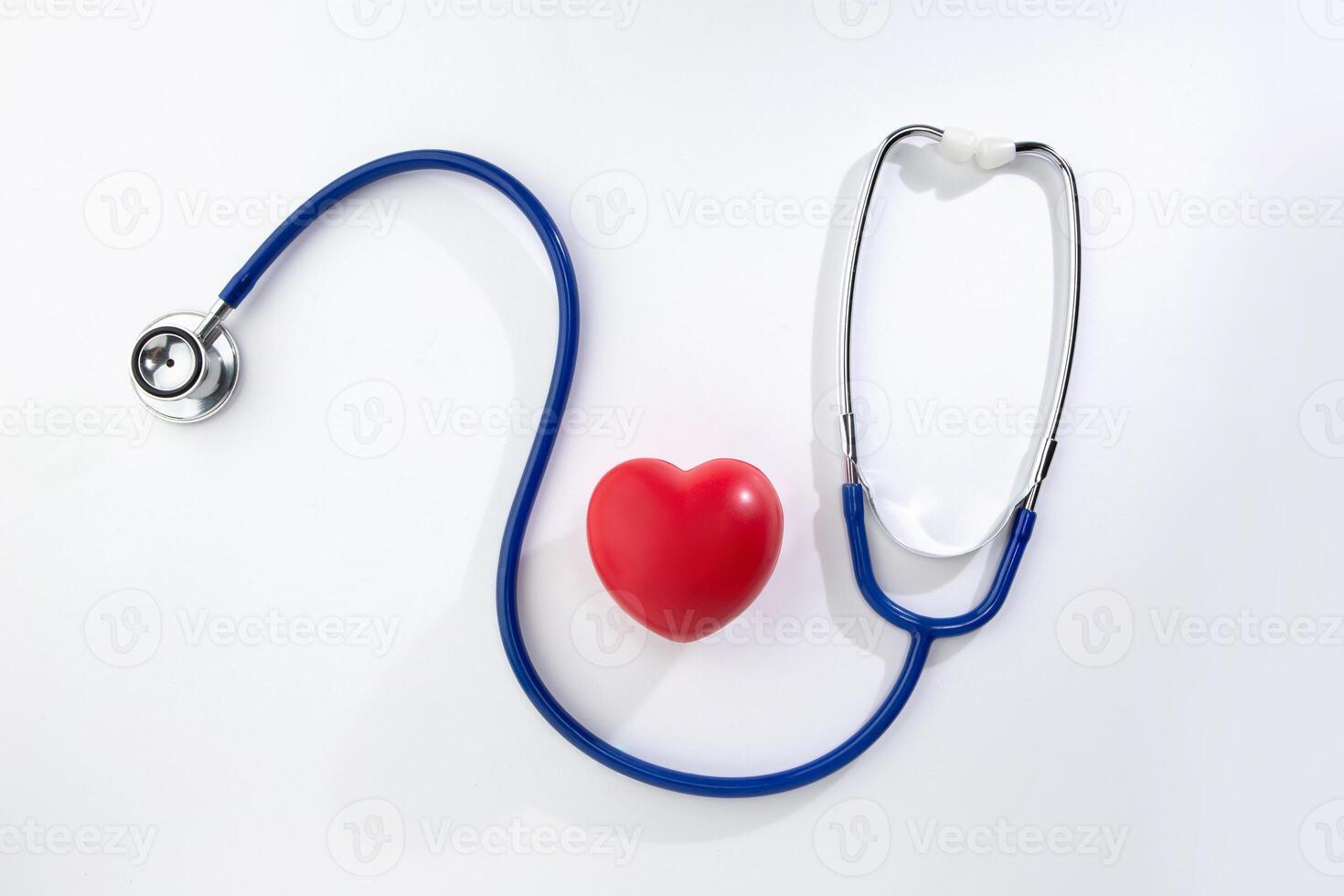 Red decorative heart and stethoscope isolated on white background photo