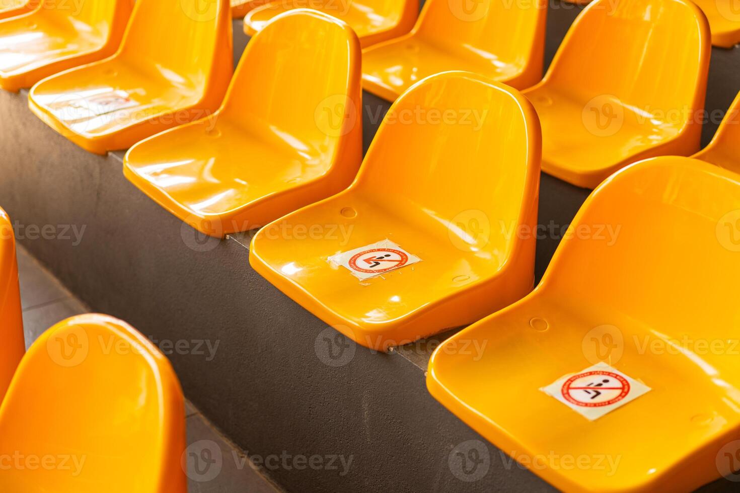 Plenty of yellow plastic seats at stadium. photo