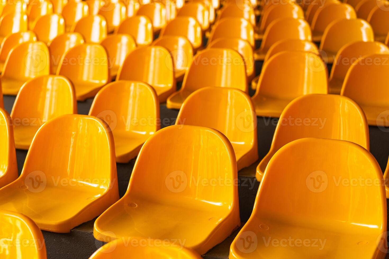 Plenty of yellow plastic seats at stadium. photo