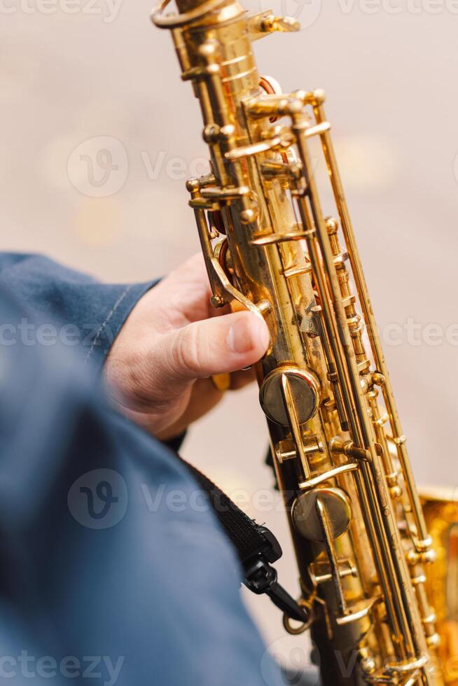 A saxophonist performs in a serene park during autumn while seated on a bench photo
