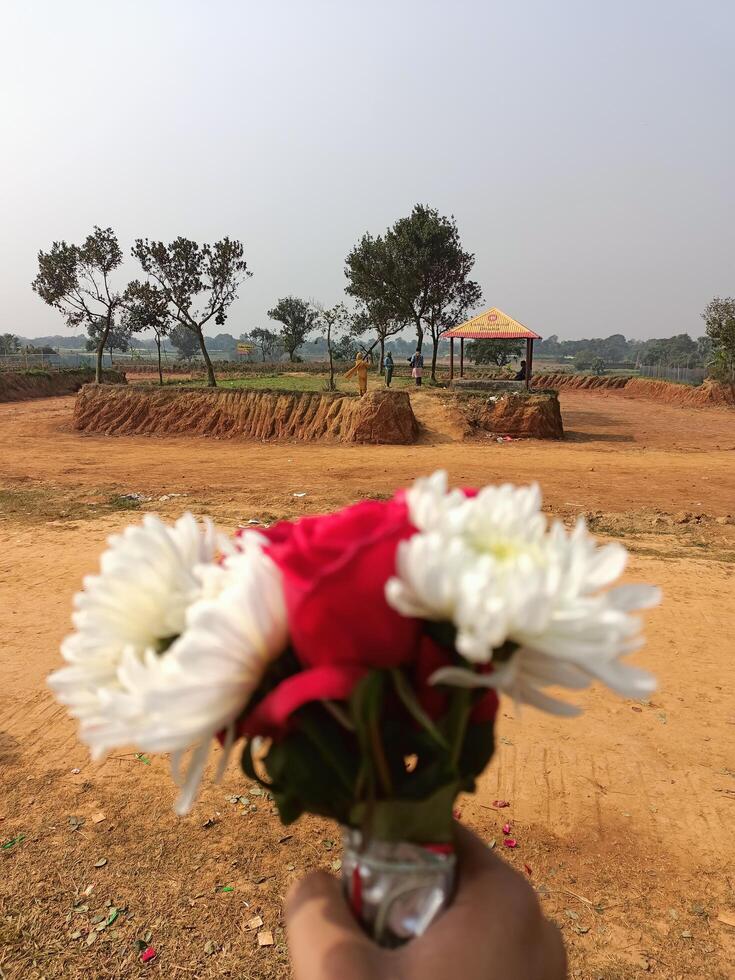 A hand holding a bunch of flowers photo