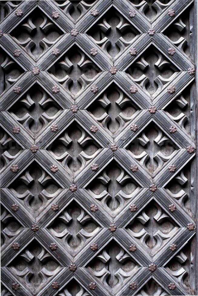 a close up of a decorative pattern of a wooden door. photo