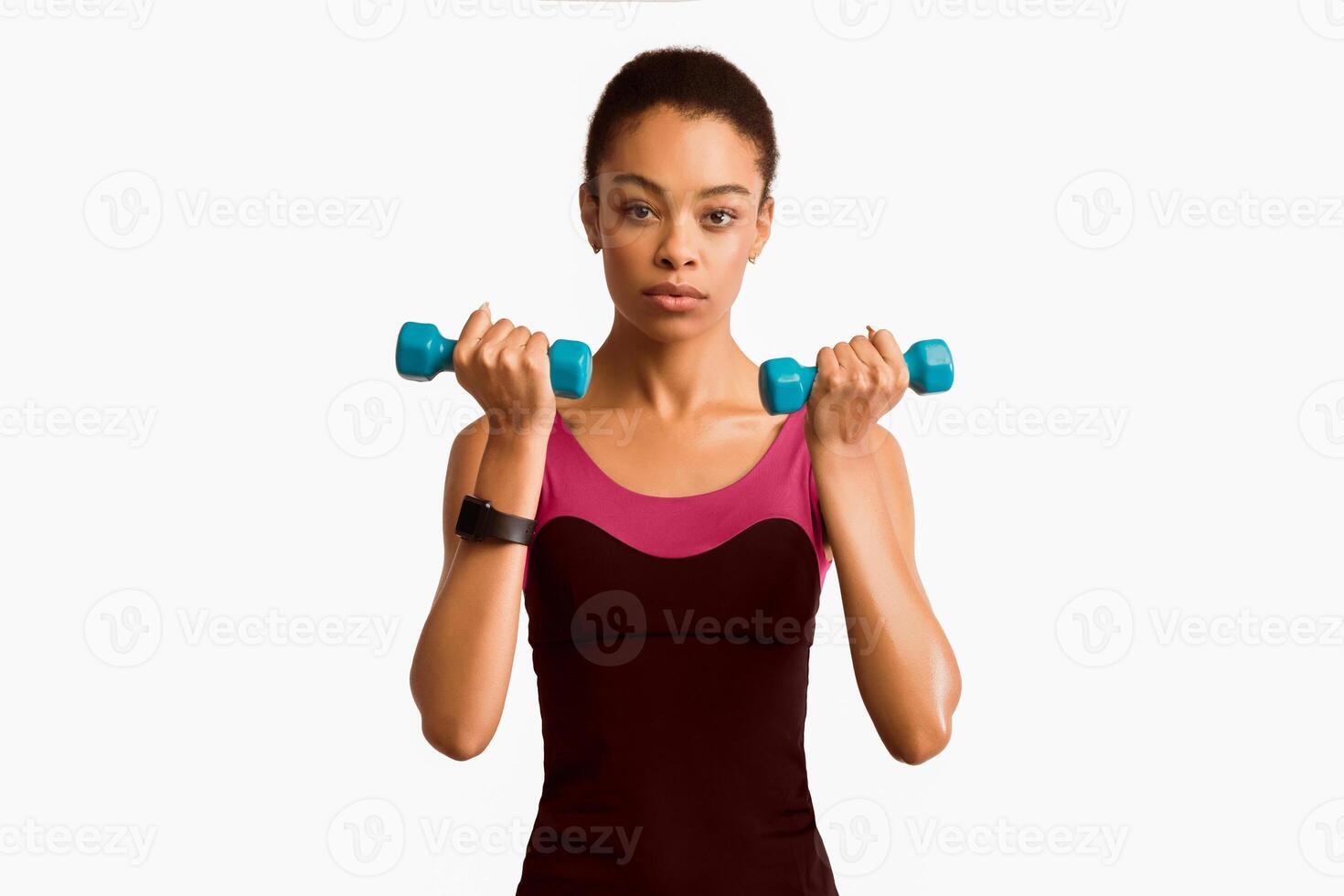 Black Woman Exercising Doing Dumbbell Biceps Curls During Workout On White Studio Background. Isolated photo