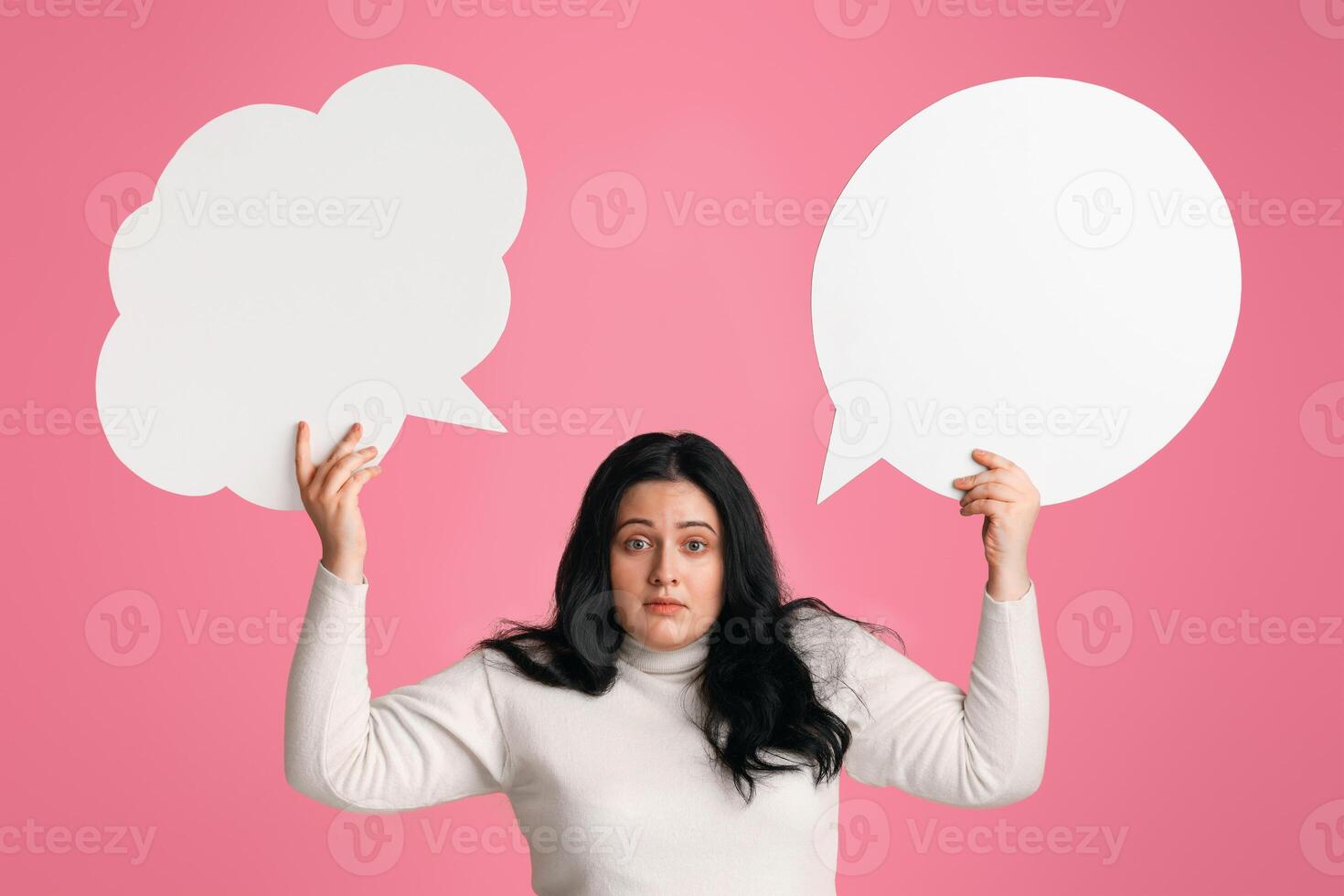 Complex Desicion. Puzzled Obese Girl Holding Two Empty Speech Bubbles Above Her Head And Looking At Camera, Panorama photo