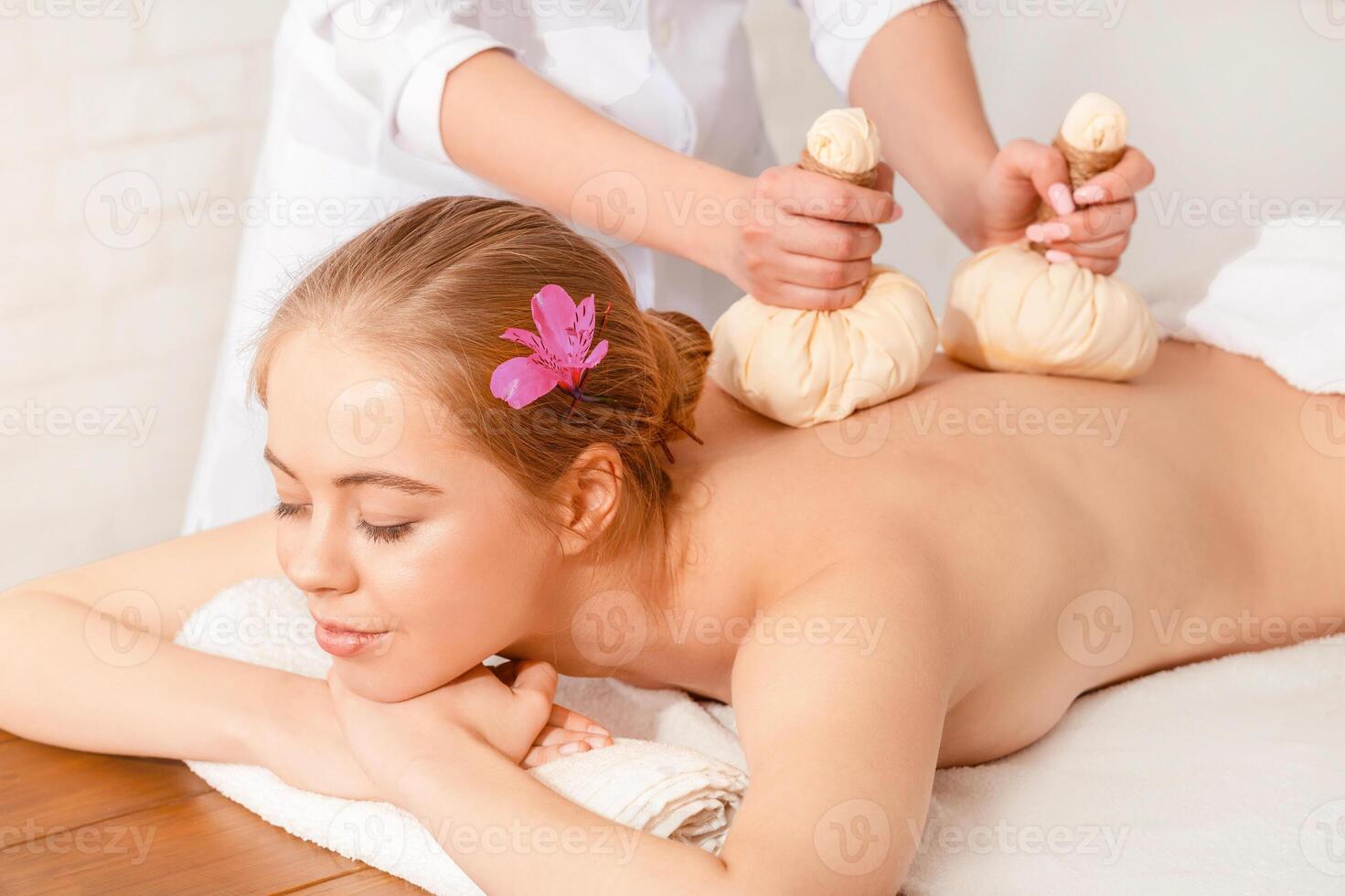 Spa and wellness center. Portrait young woman with closed eyes during massage photo