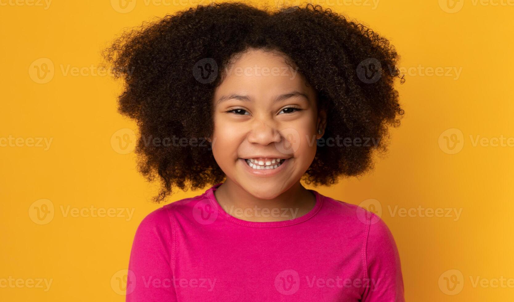 Closeup Portrait Of Funny Cute African American Little Girl Laughing At Camera, Posing Over Yellow Background In Studio, Free Space photo
