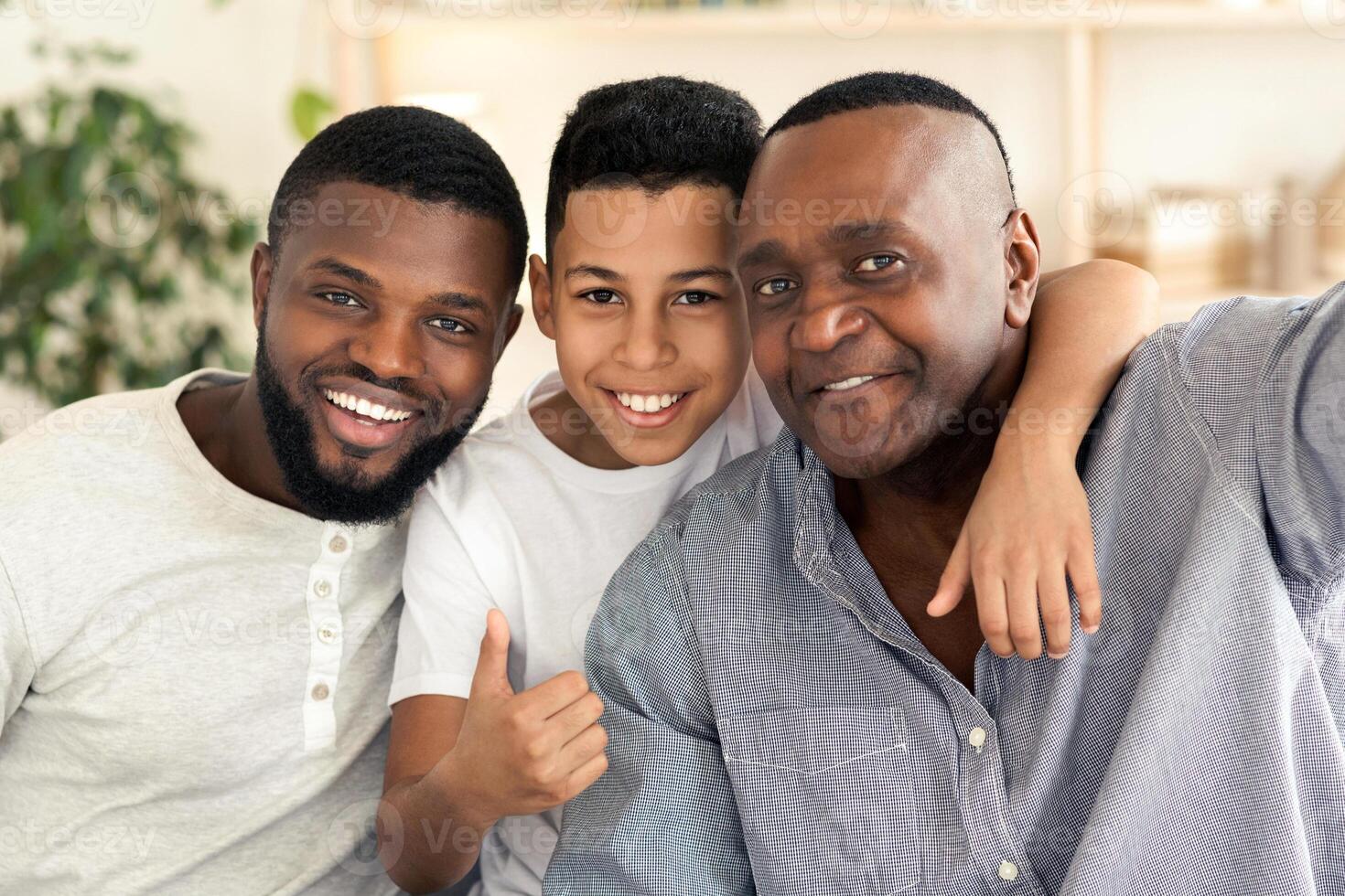Smiling Senior Black Man Taking Selfie With His Son And Grandson At Home, Posing To Camera Together, Closeup photo
