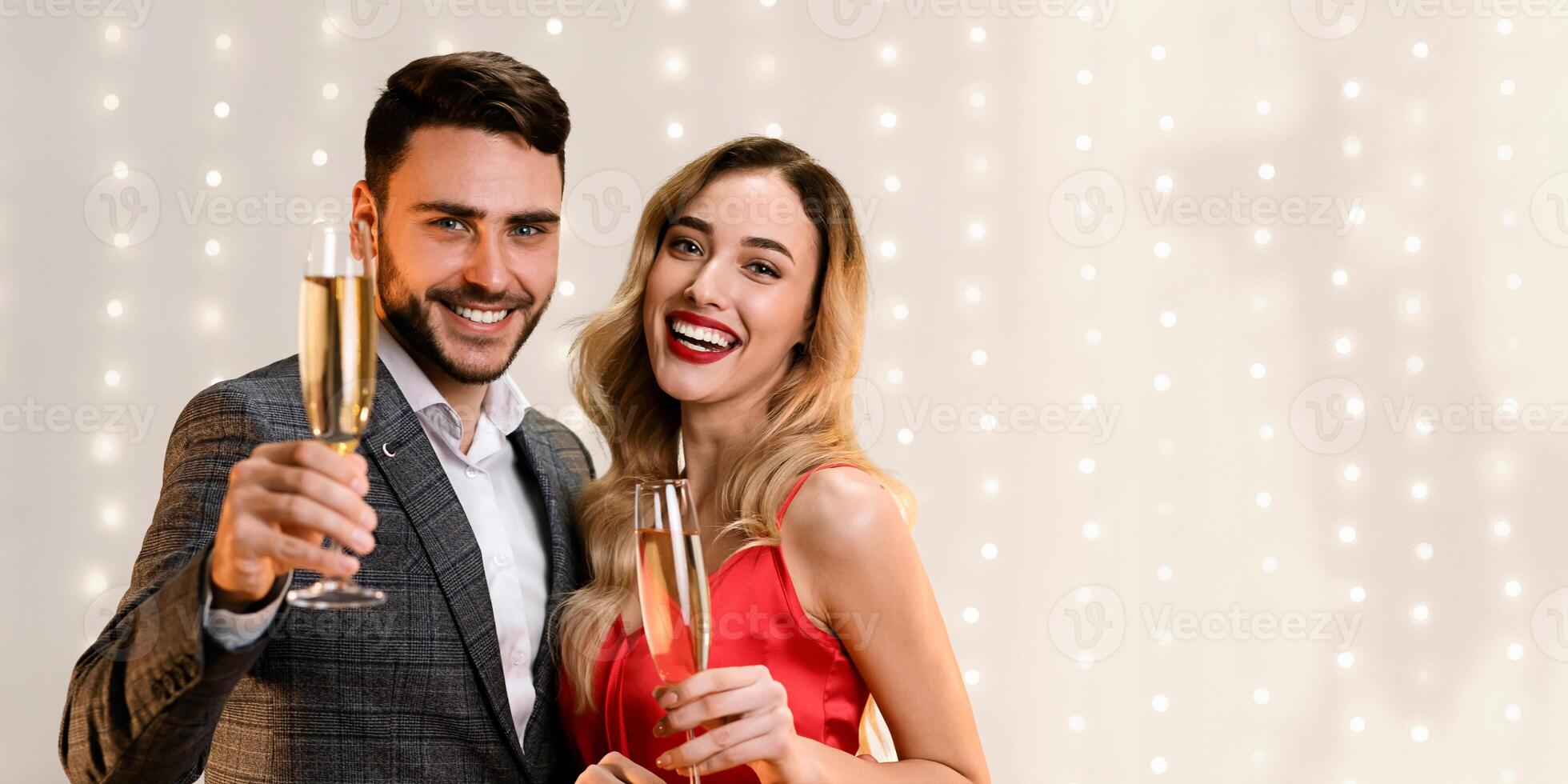 Cheers. Romantic Couple Posing With Champagne Glasses, Greeting With Holidays, Congratulating With Valentine's Day, Empty Space photo