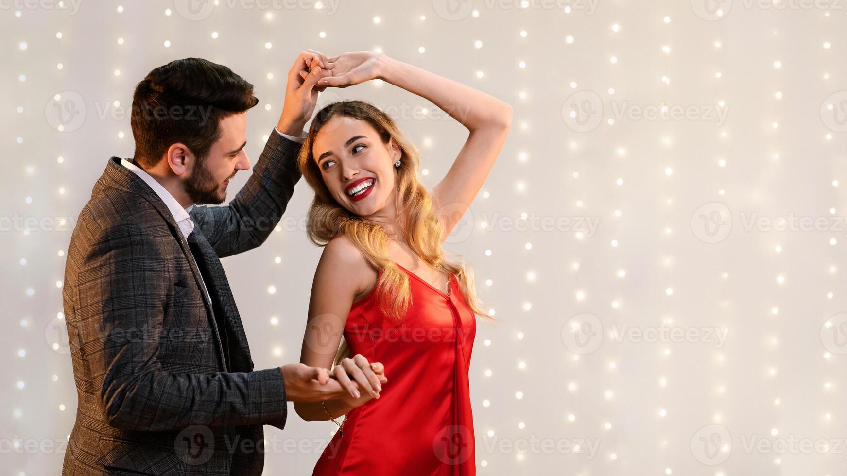 Cheerful Romantic Couple Dancing Together On Date In Restaurant, Holding Hands And Enjoying Valentine's Day Celebration, Empty Space photo