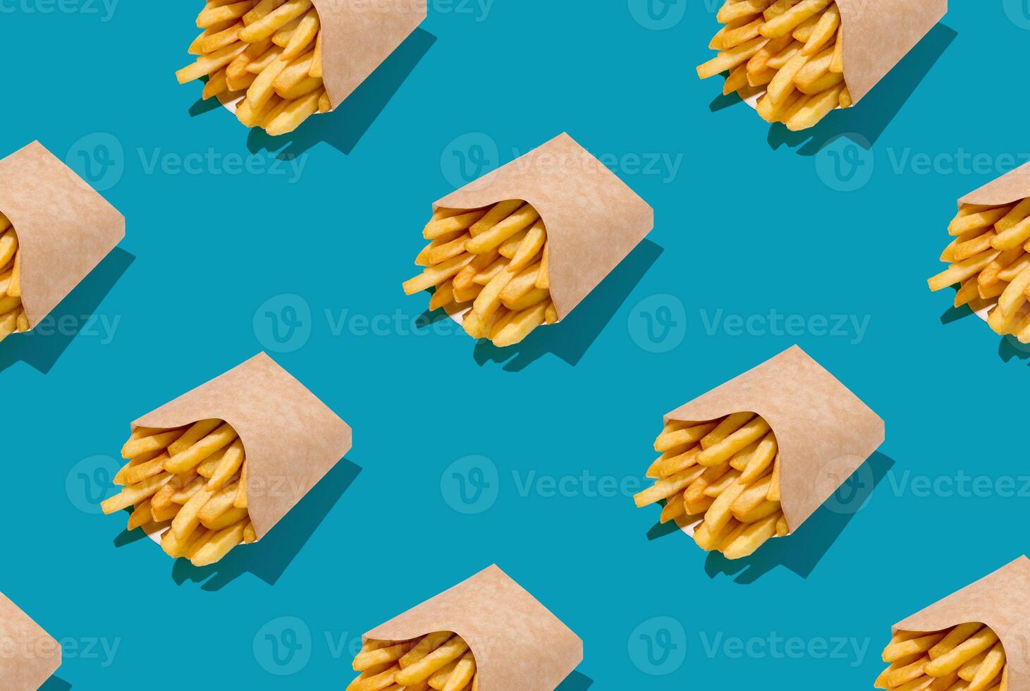 Lots Of French Fries In Paper Boxes Over Blue Background, Geometric Seamless Design, Creative Repeat Pattern, Top View photo