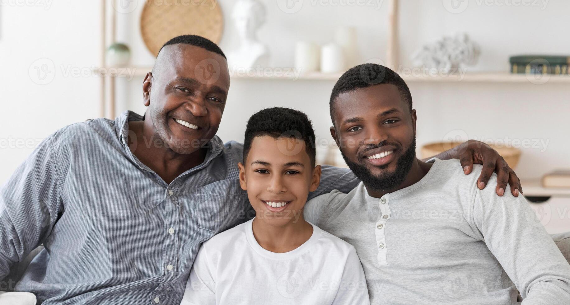 Handsome Senior African Man Embracing His Son And Grandson At Home And Posing To Camera Together, Panorama photo