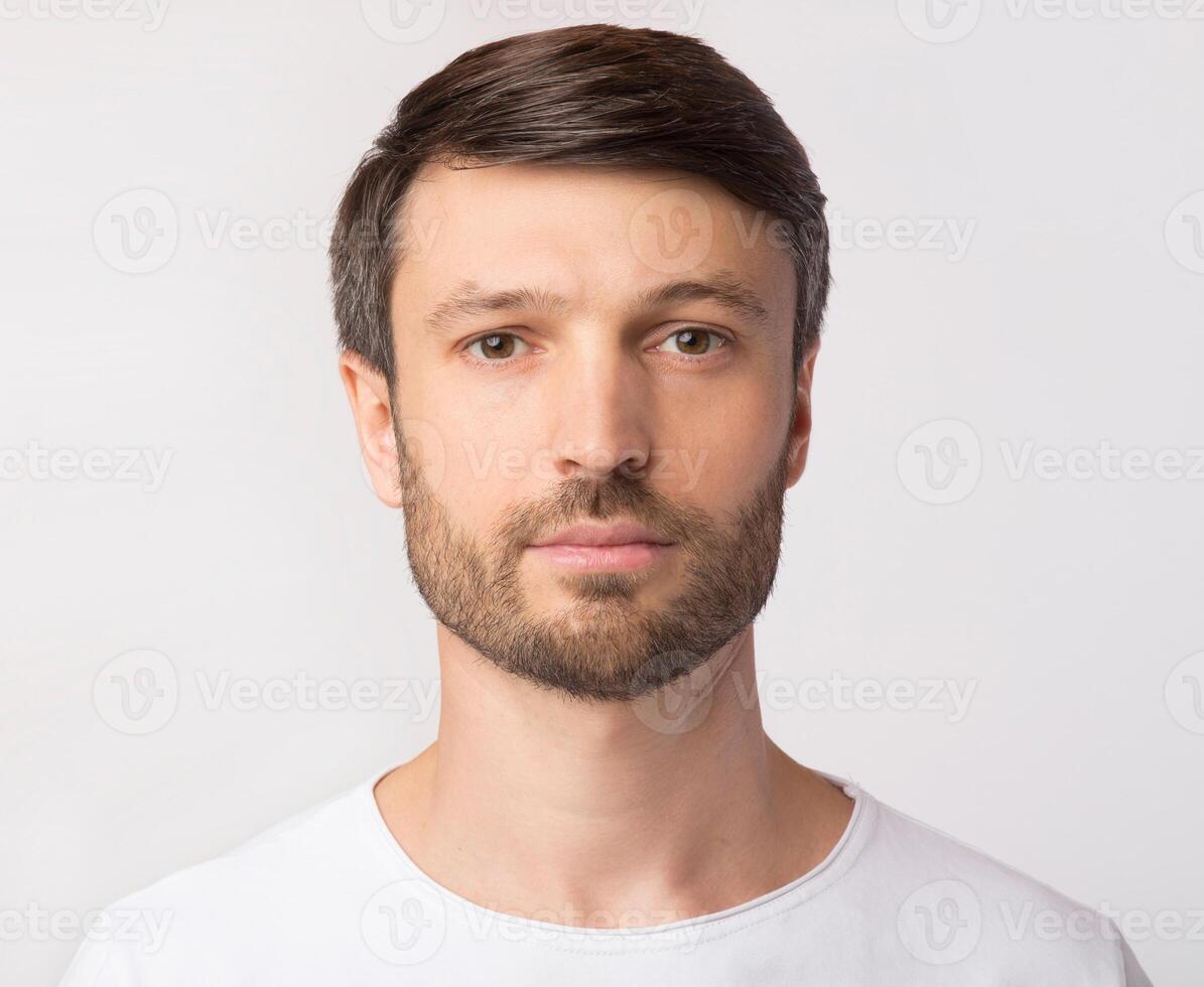 Passport Photo. Portrait Of Middle Aged Man Looking At Camera Over White Studio Background. Isolated photo