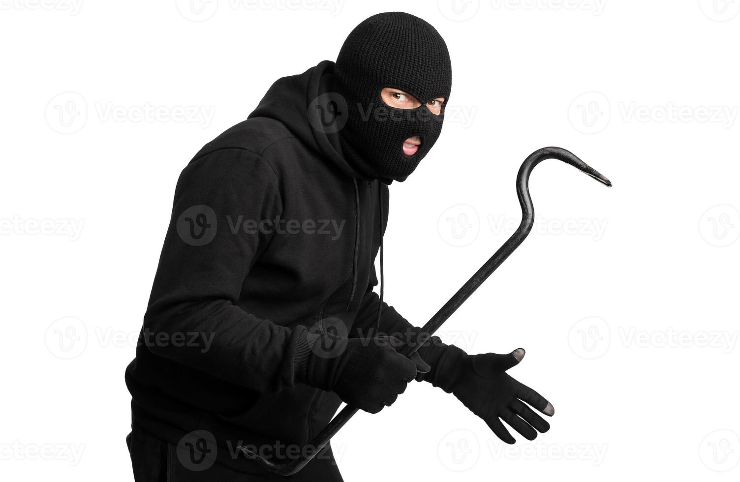 Cat Burglar Concept. Portrait of sneaky masked criminal holding crowbar, copy space, isolated over white studio wall photo