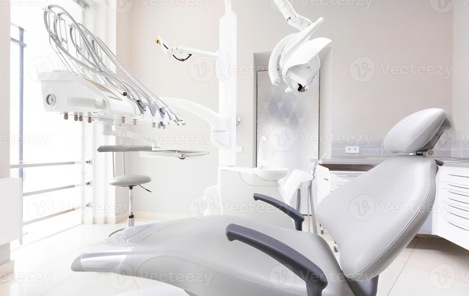 Modern Dental Clinic, Dentist chair and other medical accessories in room. Dental surgeon, copy space photo