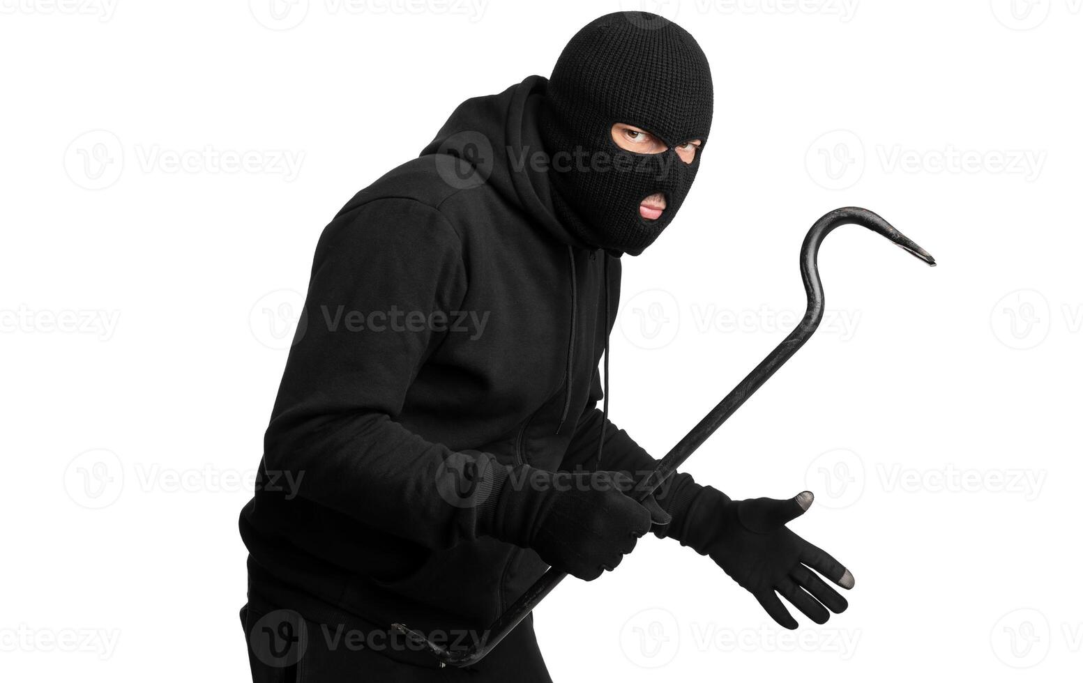 Violence Concept. Half-turned thief wearing black mask and hoodie looking angrily at camera, isolated on white background photo