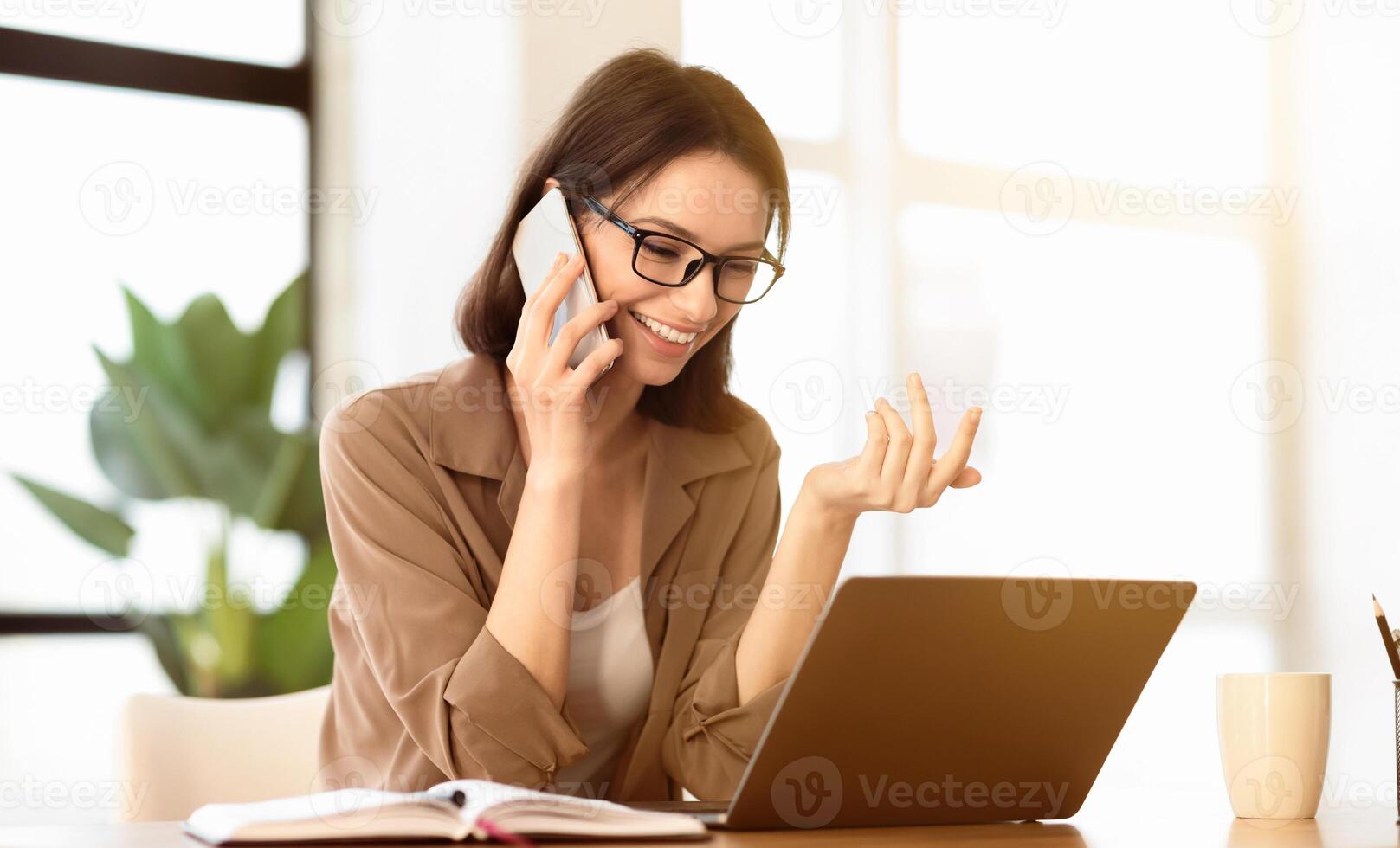 Business Call. Happy woman talking on mobile phone, consulting client, using laptop, gesturing, copyspace photo