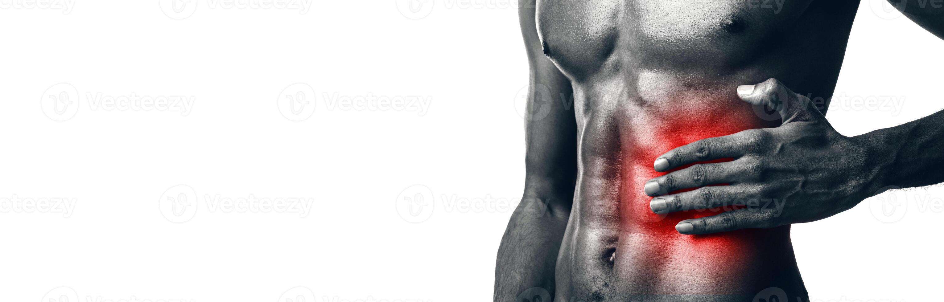 Workout Injuries. Unrecognizable Athlete Man Touching Abs Muscle Suffering From Pain Standing On White Studio Background. Cropped, Panorama, Black-And-White photo