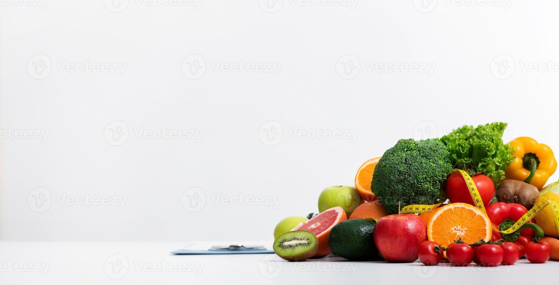 Fresh fruits and vegetables over black ladies dietologist and patient having conversation at clinic photo