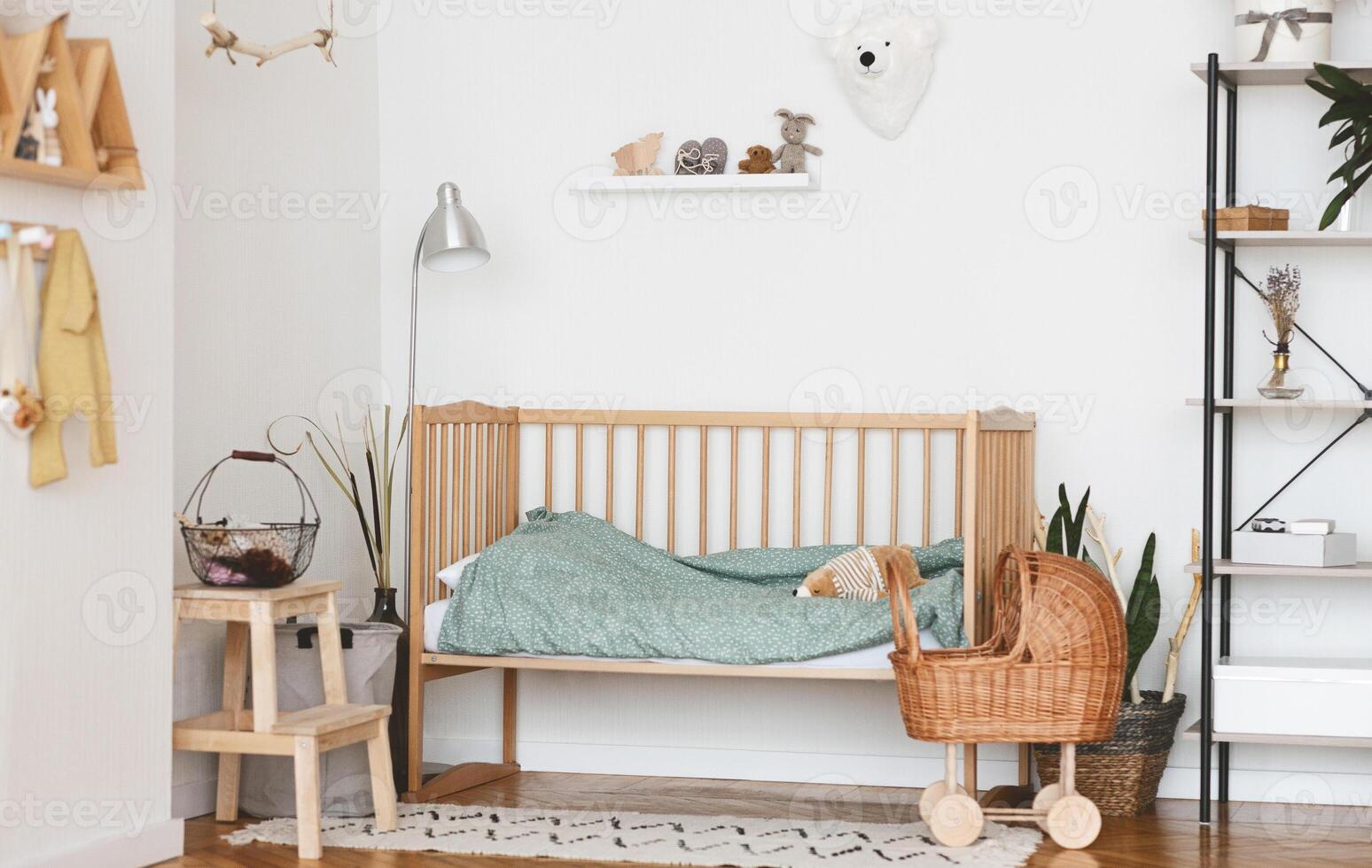 Baby Bedroom Interior with Cozy Wooden Bed, Wicker Stroller and Rack In Scandinavian Style photo