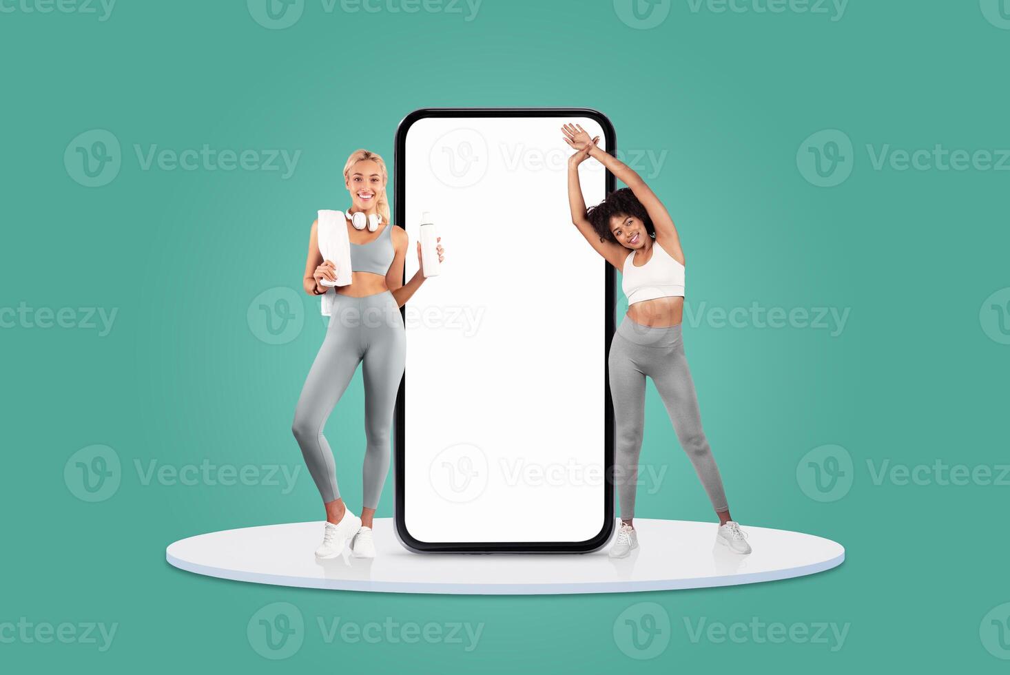 Two women are engaged in stretching and fitness activities near a giant smartphone. They wear workout attire and appear motivated in a vibrant, cheerful environment. photo
