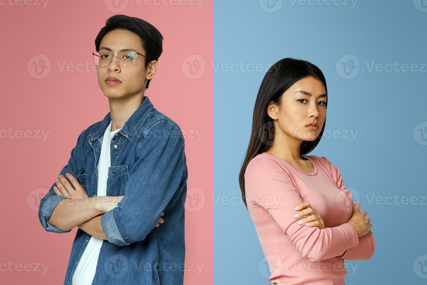 Break up. Upset asian man and woman standing back to back, gray studio background photo