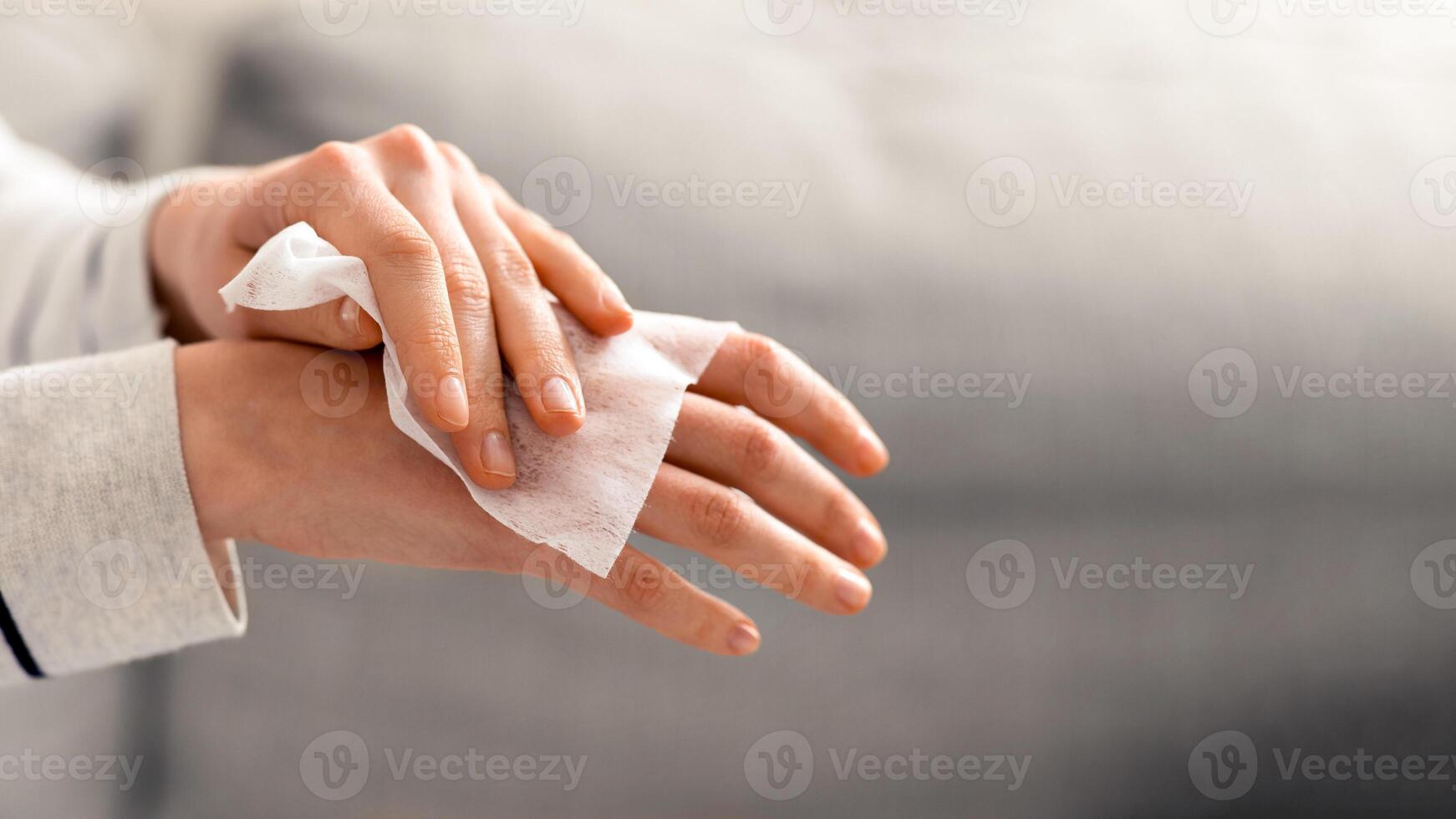 Personal hygiene. Woman disinfecting hands with antibacterial alcoholic napkins, close up photo